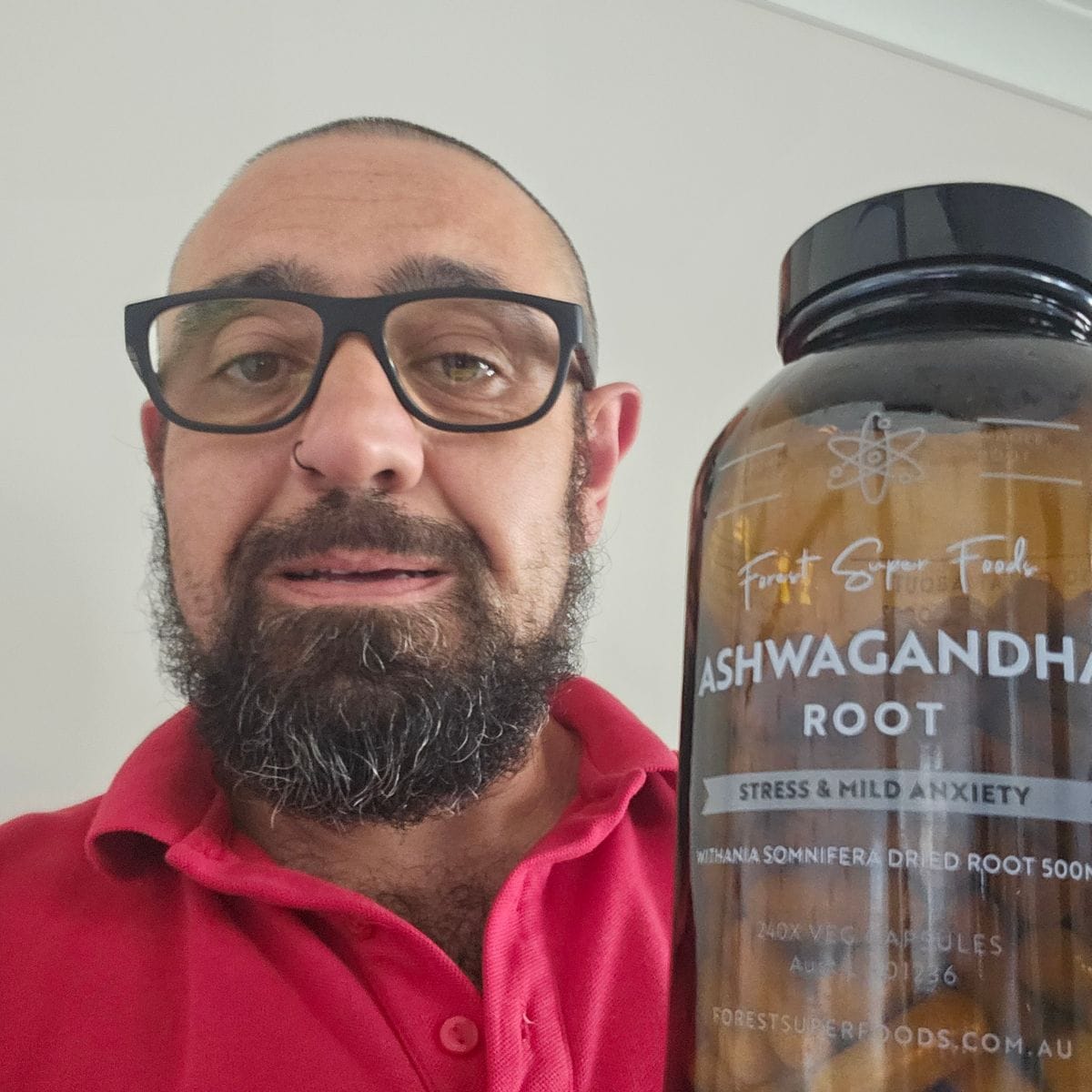 Customer holding a bottle of Forest Super Foods Ashwagandha capsules
